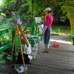 Student painting at the Wisteria Bridge in Monet's Garden
