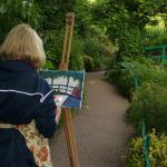 Student painting at the Wisteria Bridge in Monet's Garden