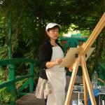 Student painting on the Wisteria Bridge in Monet's Garden